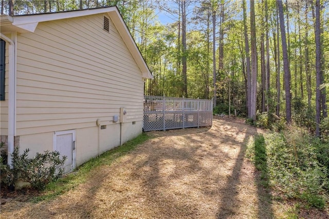 view of side of home featuring a deck and crawl space
