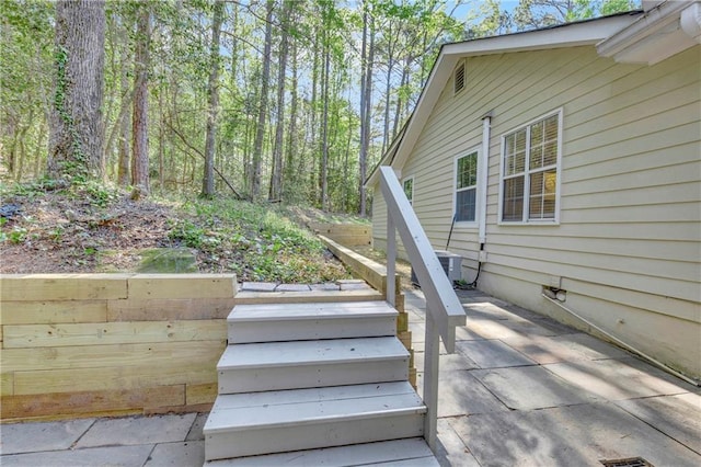 exterior space featuring a patio, stairs, and central AC