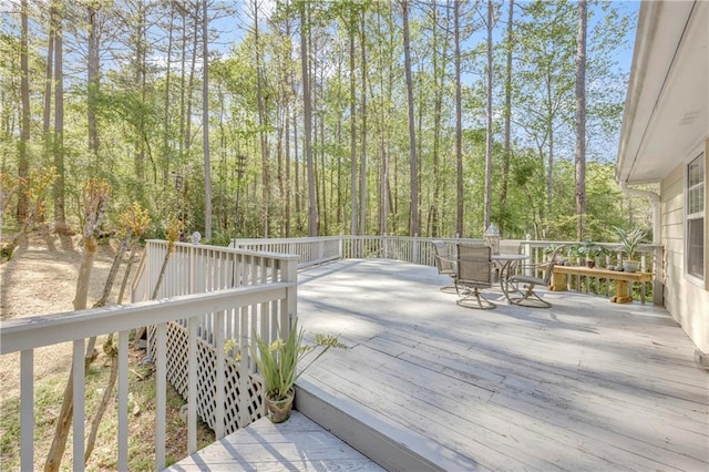 wooden terrace with outdoor dining space
