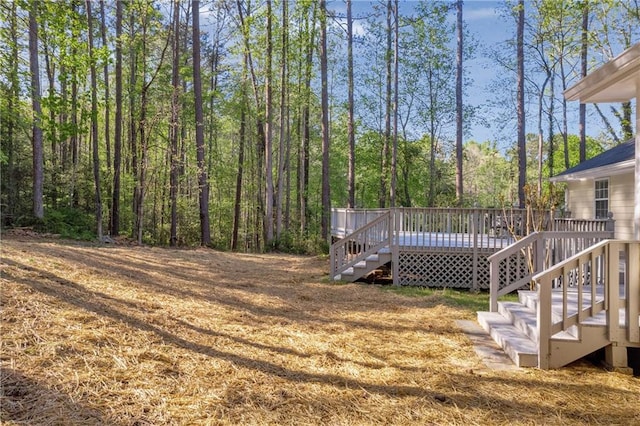 view of yard with a wooden deck and stairway