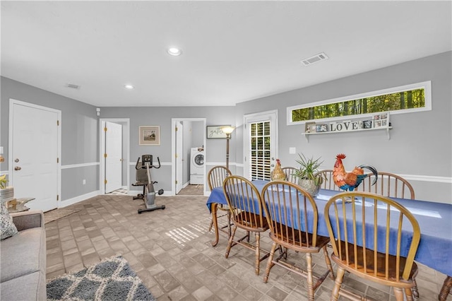 dining space with visible vents, washer / clothes dryer, a wealth of natural light, and baseboards