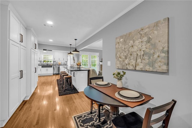 dining area featuring visible vents, ornamental molding, recessed lighting, french doors, and light wood-style flooring