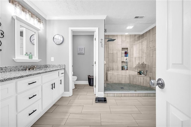 full bathroom with vanity, baseboards, a stall shower, toilet, and visible vents