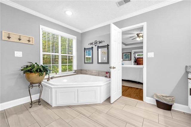 ensuite bathroom with a garden tub, connected bathroom, a ceiling fan, ornamental molding, and visible vents