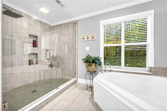 bathroom with a shower stall, a garden tub, visible vents, and crown molding