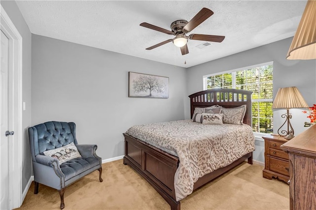 bedroom with visible vents, baseboards, and light carpet