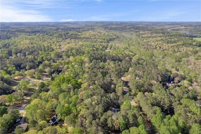 bird's eye view featuring a wooded view