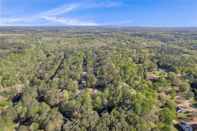 drone / aerial view with a wooded view