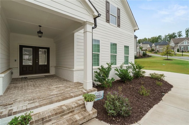 property entrance with a lawn and a porch