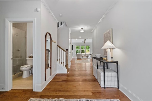 entrance foyer with ornamental molding and wood-type flooring