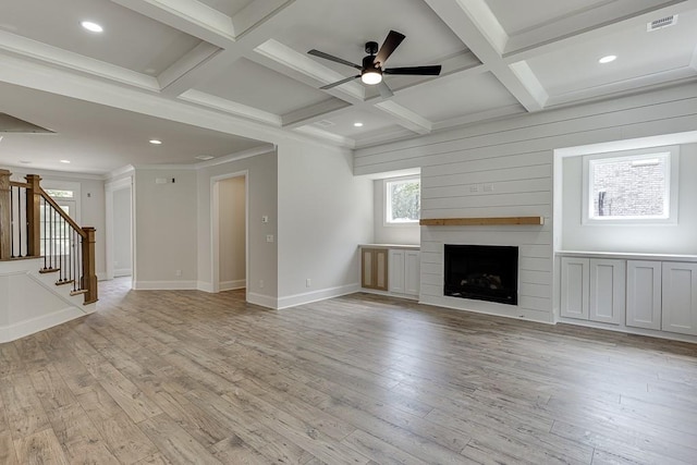 unfurnished living room featuring beamed ceiling, light wood-type flooring, ceiling fan, and coffered ceiling