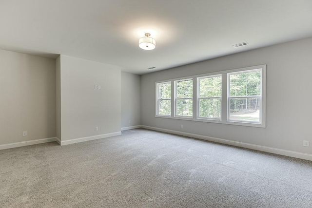 unfurnished room featuring light colored carpet