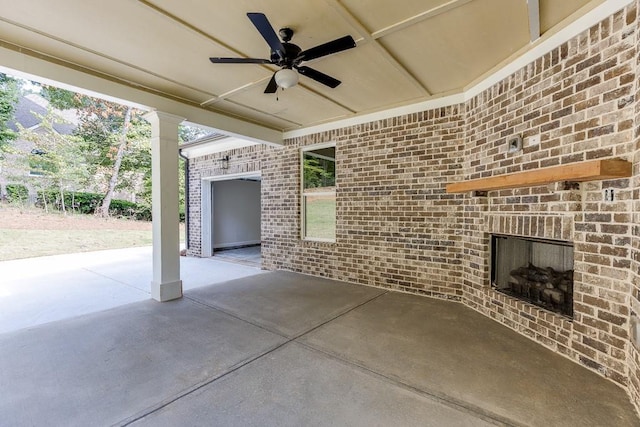 view of patio featuring an outdoor brick fireplace and ceiling fan