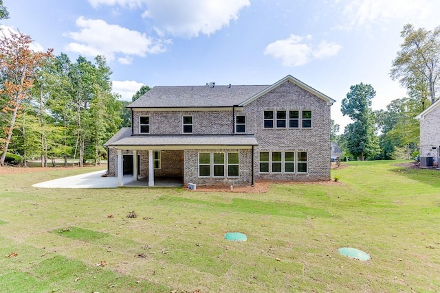 rear view of house featuring central AC, a yard, and a patio