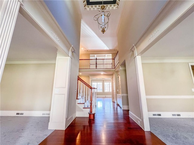 3212 Woodhaven Ct SW, Conyers, GA 30094 - entrance foyer with crown molding, baseboards, visible vents, and stairway