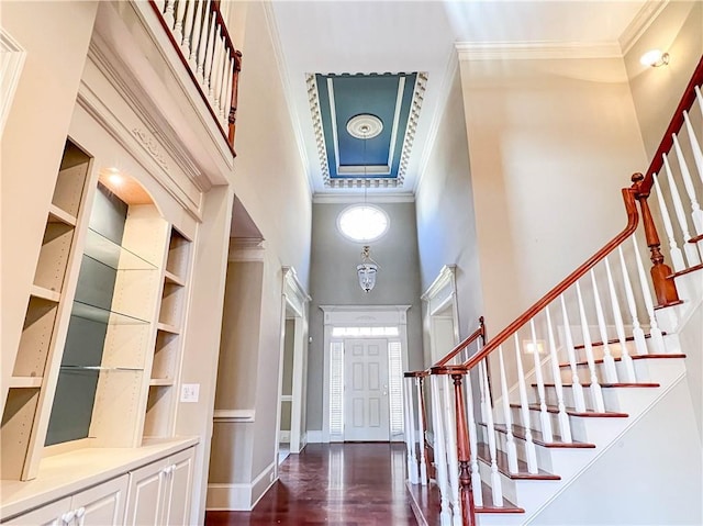 3212 Woodhaven Ct SW, Conyers, GA 30094 - foyer entrance with a towering ceiling, baseboards, dark wood-style floors, ornamental molding, and stairs