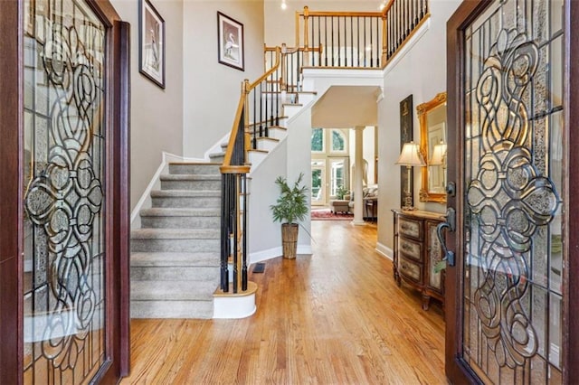 foyer featuring a high ceiling and light hardwood / wood-style floors