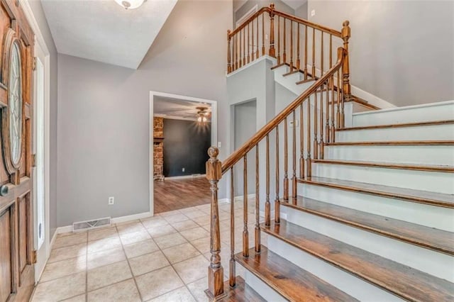 227 Margo Trl, Rome, GA 30161 - tiled entrance foyer with stairs, ceiling fan, baseboards, and high vaulted ceiling