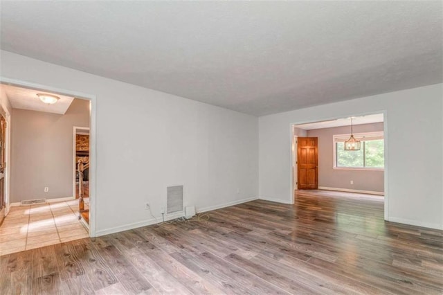 227 Margo Trl, Rome, GA 30161 - spare room featuring wood finished floors, baseboards, and a chandelier