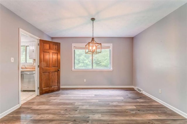 227 Margo Trl, Rome, GA 30161 - unfurnished dining area with a chandelier, wood finished floors, and baseboards