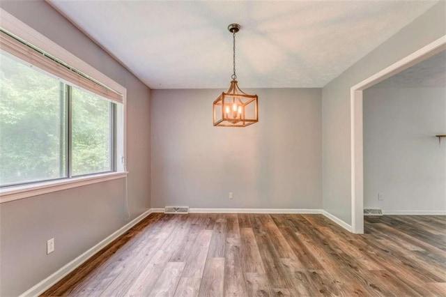 227 Margo Trl, Rome, GA 30161 - empty room with wood finished floors, a chandelier, and baseboards