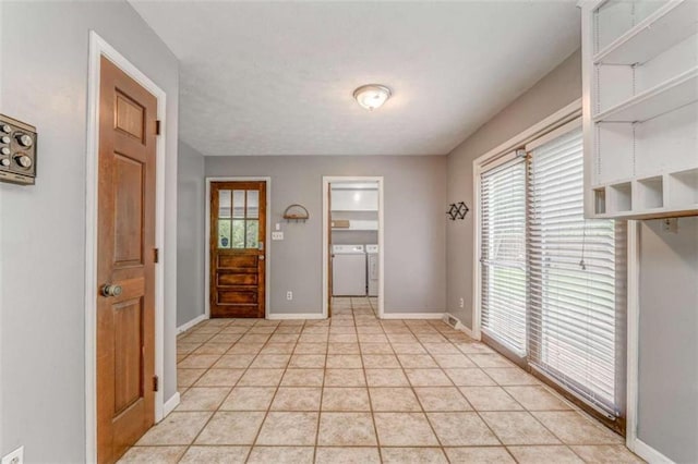 227 Margo Trl, Rome, GA 30161 - entrance foyer featuring washing machine and clothes dryer, plenty of natural light, baseboards, and light tile patterned flooring