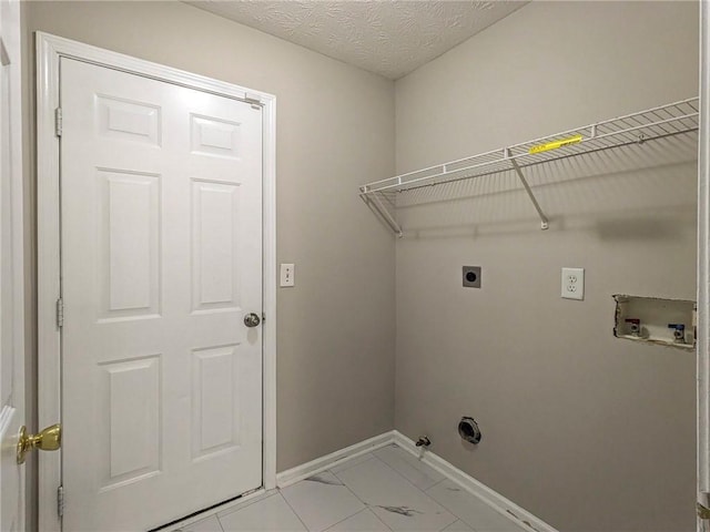 clothes washing area featuring electric dryer hookup, gas dryer hookup, washer hookup, a textured ceiling, and light tile patterned flooring