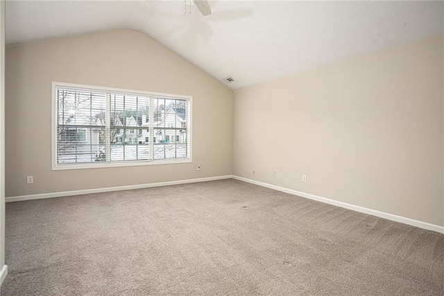 carpeted empty room with ceiling fan and vaulted ceiling