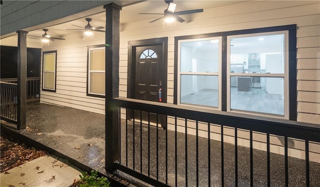 doorway to property with covered porch and ceiling fan