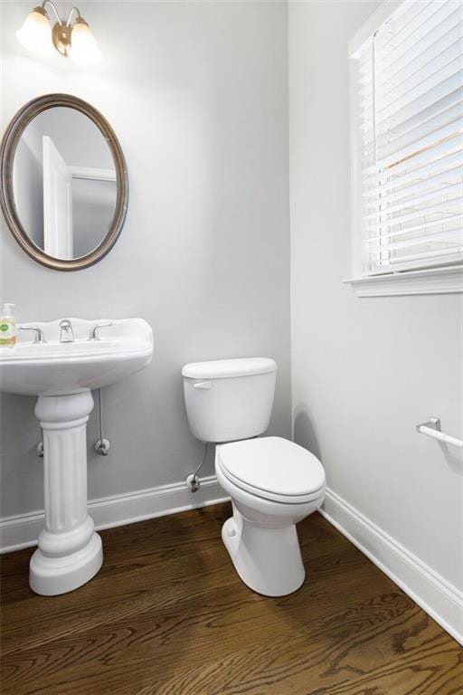 bathroom featuring wood-type flooring and toilet