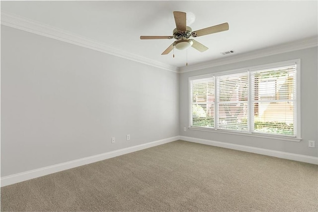 empty room with ornamental molding, a healthy amount of sunlight, and carpet