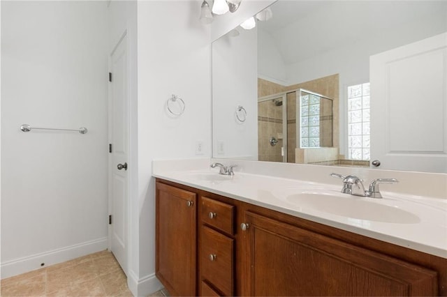 bathroom featuring vanity, tile patterned flooring, and a shower with shower door