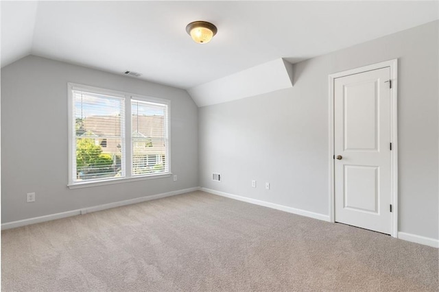 bonus room featuring vaulted ceiling and carpet