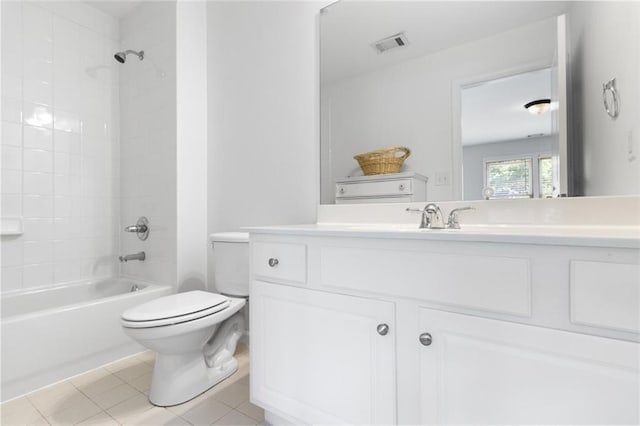 full bathroom featuring tiled shower / bath, vanity, toilet, and tile patterned flooring