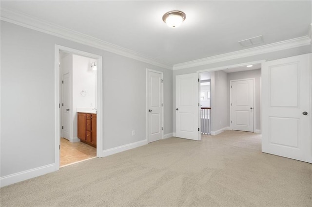 unfurnished bedroom featuring crown molding, ensuite bath, and light carpet