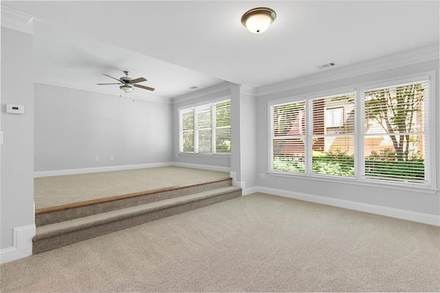 empty room featuring ceiling fan, ornamental molding, and carpet floors