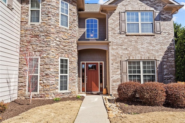 doorway to property with brick siding