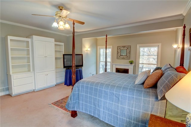 carpeted bedroom featuring crown molding and ceiling fan