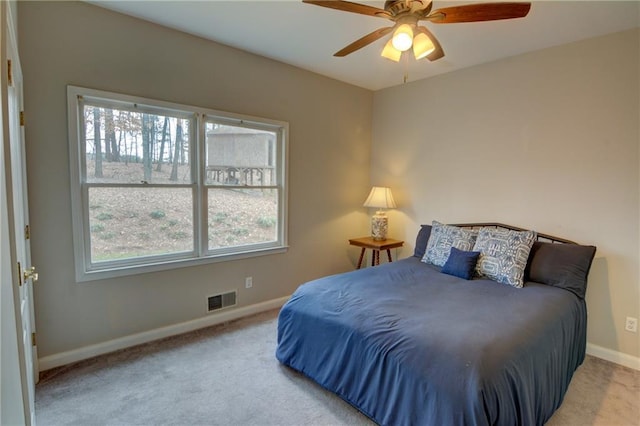 bedroom with light colored carpet and ceiling fan