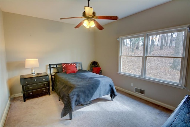 bedroom with light colored carpet and ceiling fan