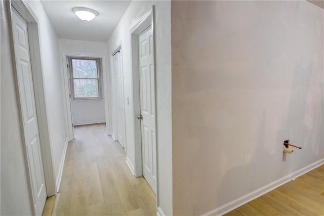 hall with light hardwood / wood-style floors