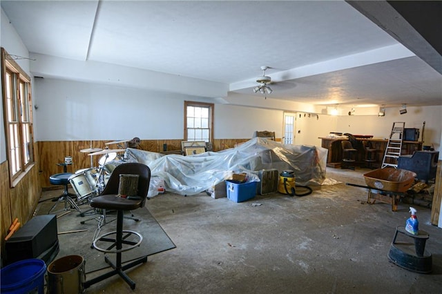 interior space featuring wooden walls, concrete floors, and indoor bar