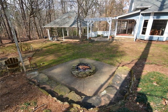 view of yard with a pergola, a patio, and an outdoor fire pit