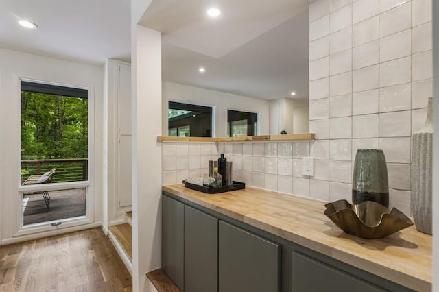 bar featuring a dry bar, decorative backsplash, recessed lighting, and wood finished floors