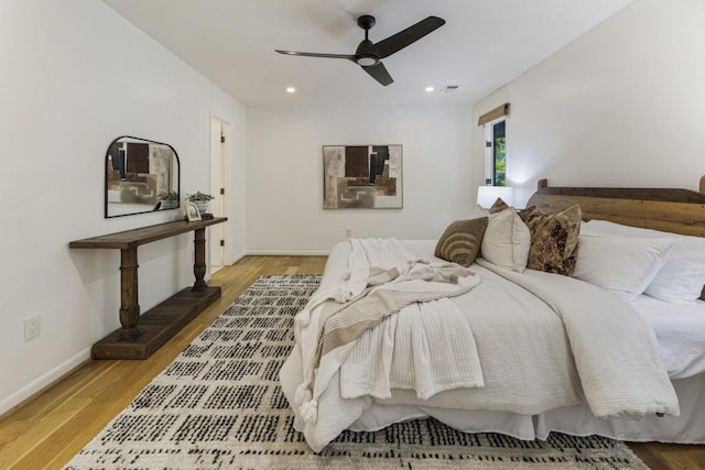 bedroom featuring baseboards, recessed lighting, and wood finished floors