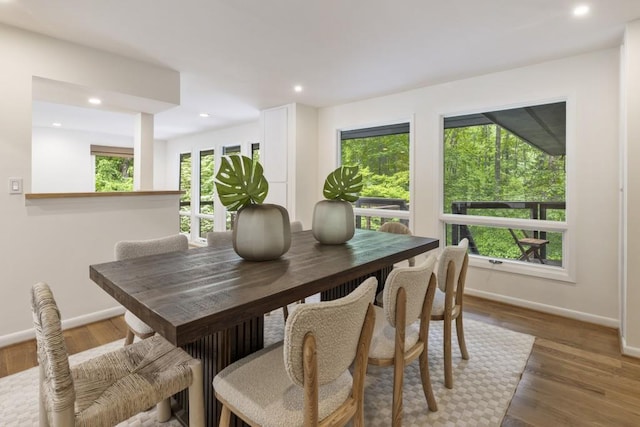 dining space with recessed lighting, baseboards, and wood finished floors