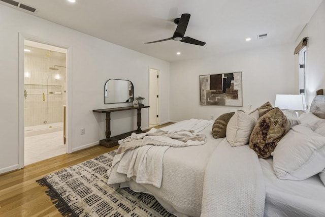 bedroom with baseboards, recessed lighting, wood finished floors, and visible vents