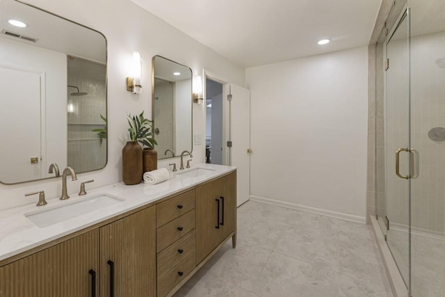 bathroom featuring visible vents, a sink, double vanity, and a shower stall