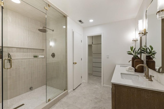 full bath featuring double vanity, visible vents, a sink, and a stall shower