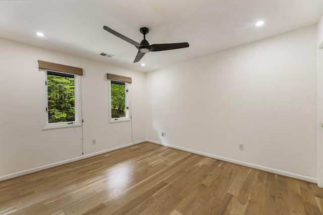 unfurnished room with ceiling fan, visible vents, light wood-type flooring, baseboards, and recessed lighting